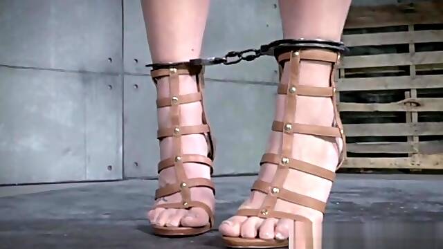 Slave mask sub has her arms chained up