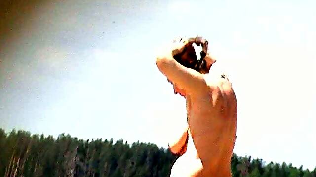 Chunky and busty white lady on the nudist beach all alone