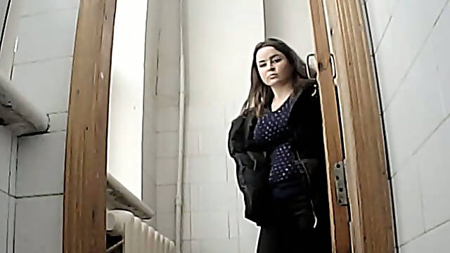 Brunette young sweetie in the public restroom pissing