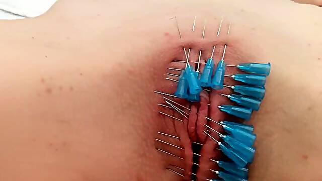 Kinky teen gets her shaved cunt sealed shut with needles