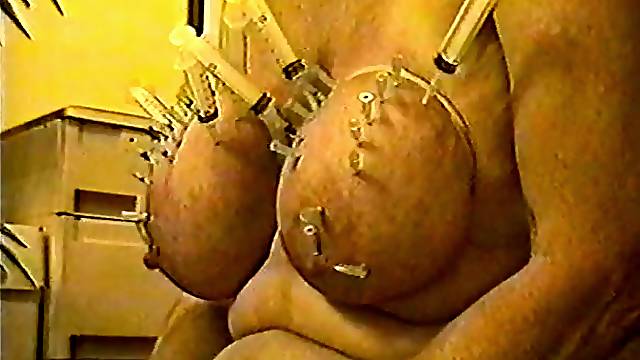 And here is my horny sow with her fat udders, pierced with a whole bunch of needles.