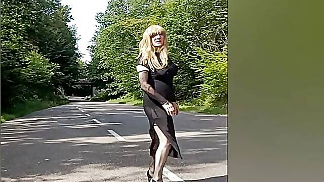 Crossdresser in transparent dress and sexy underwear outdoor
