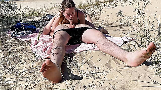 Nudist couple enjoying blowjob at the beach